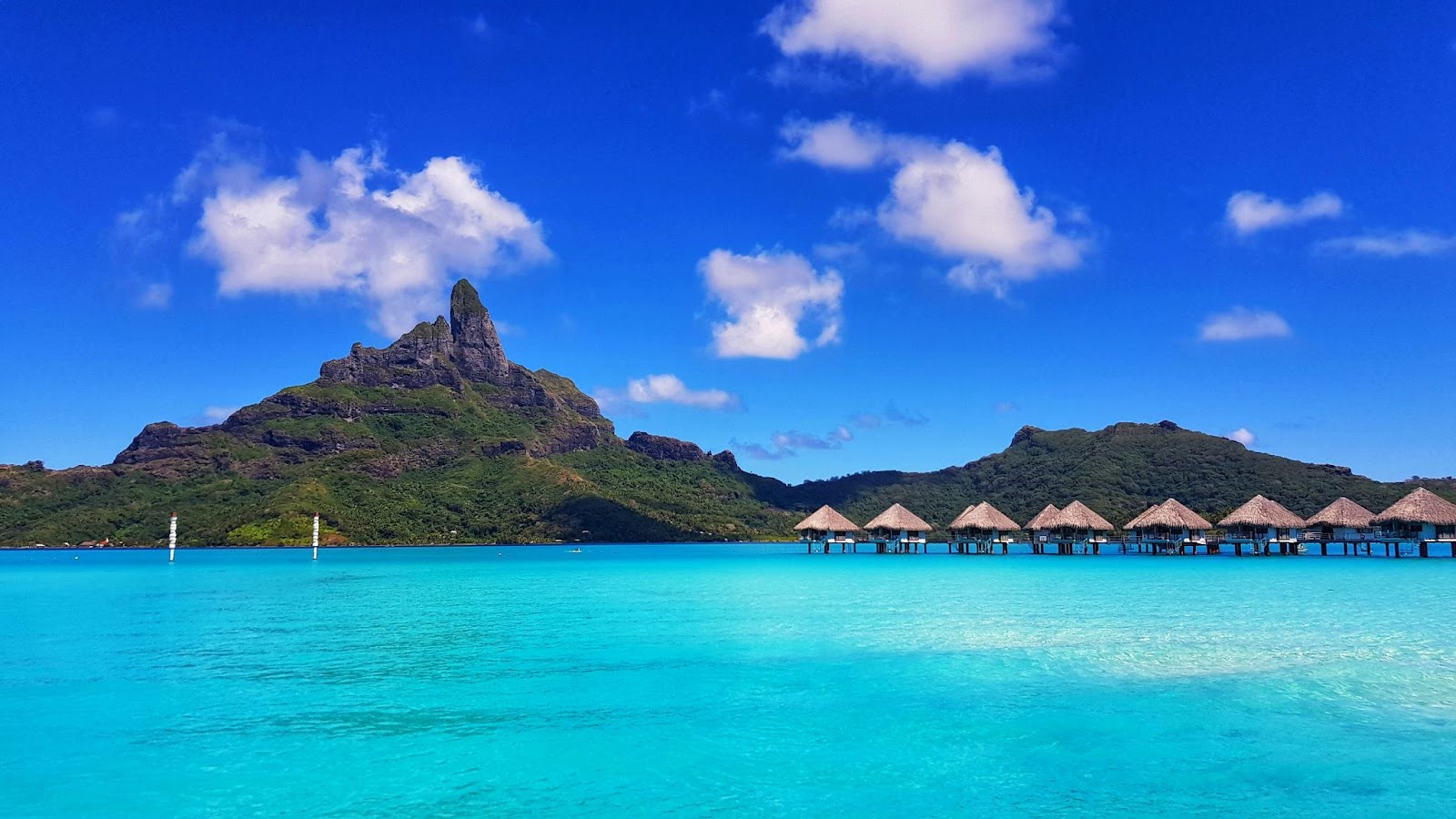 Overwater Bungalows are one of the most popular features of Bora Bora. 
pictured: underwater bungalows standing on clear blue waters in Bora Bora 