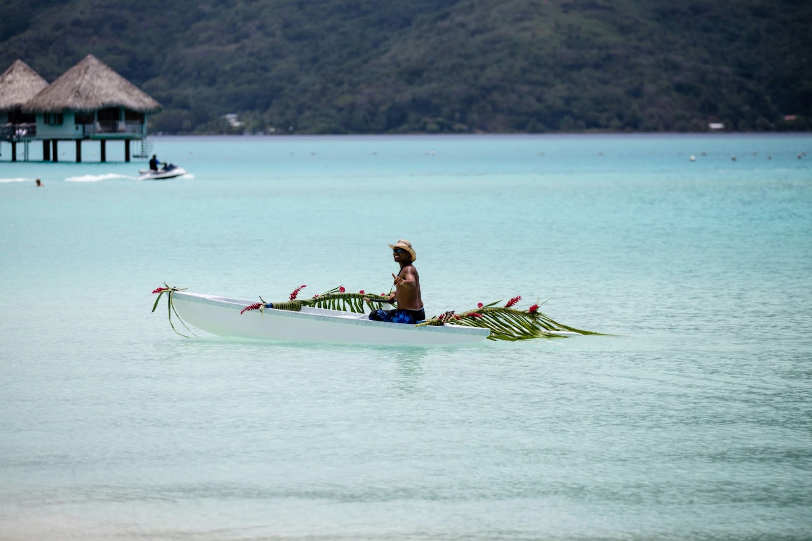 Here is a cultural event that tourists can enjoy in Bora Bora during July.
pictured: a French Polynesian man intertwining ornamented leaves  