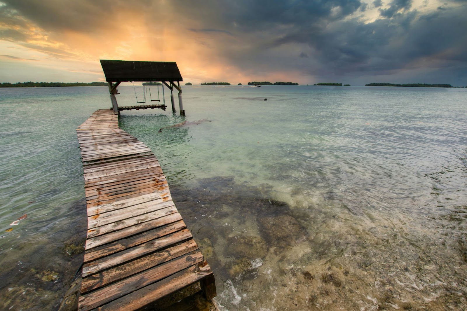 July is one of the best times to take part in aquatic activities while in Bora Bora. 
pictured: the clear water of Bora Bora near a small pier