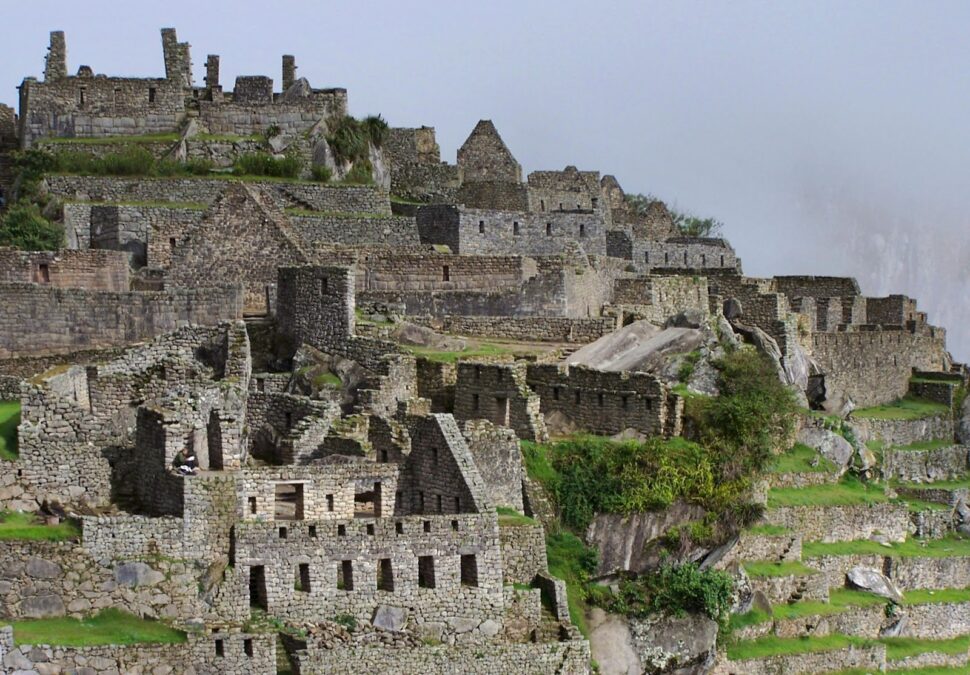 View of the Machu Picchu ruins with mountains and fog