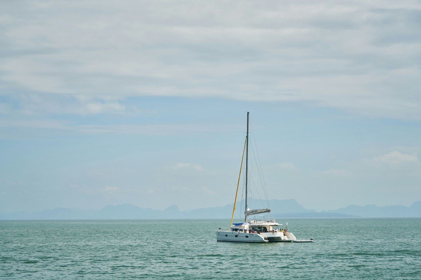 The nature in Phuket is a reason to visit during the best time to visit Thailand.
pictured: the ocean of Thailand with a catamaran boat floating