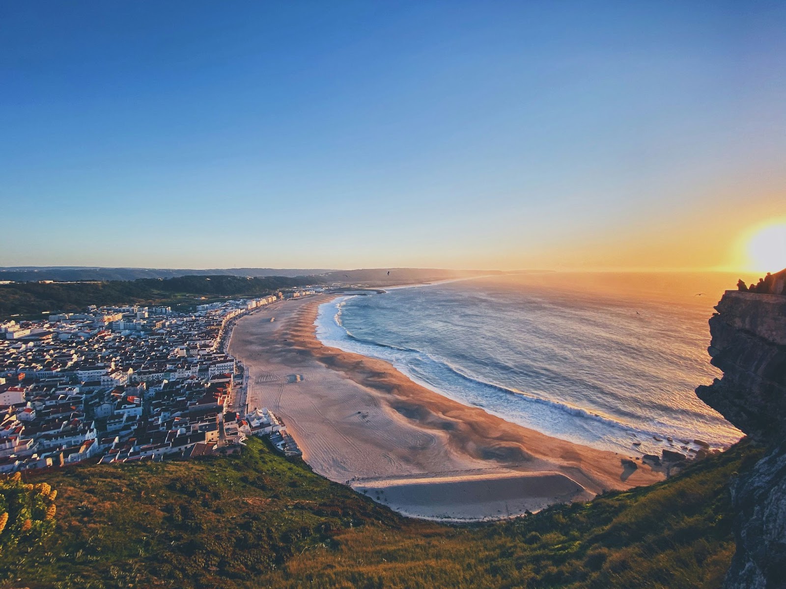 The beaches are a great reason for travelers to visit Portugal during spring. 
pictured: sunset at beach in Nazaré