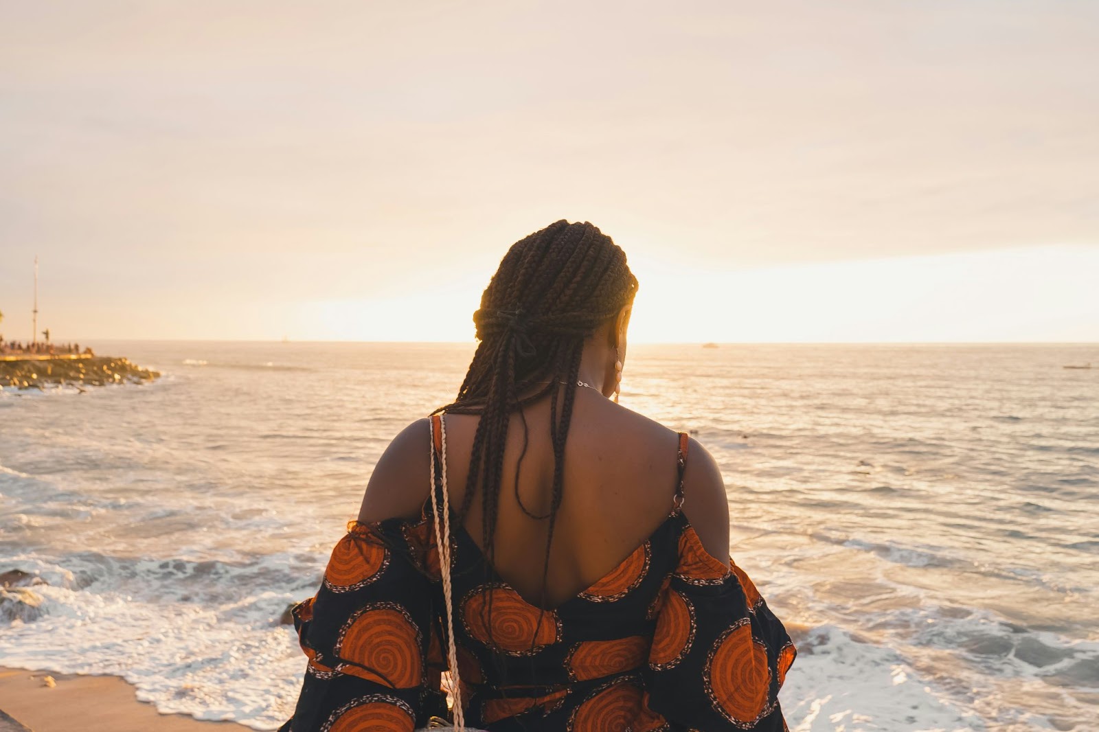 Travelers can visit Puerto Vallarta during May for Mother's Day. 
pictured: a Black woman on a beach in Puerto Vallarta