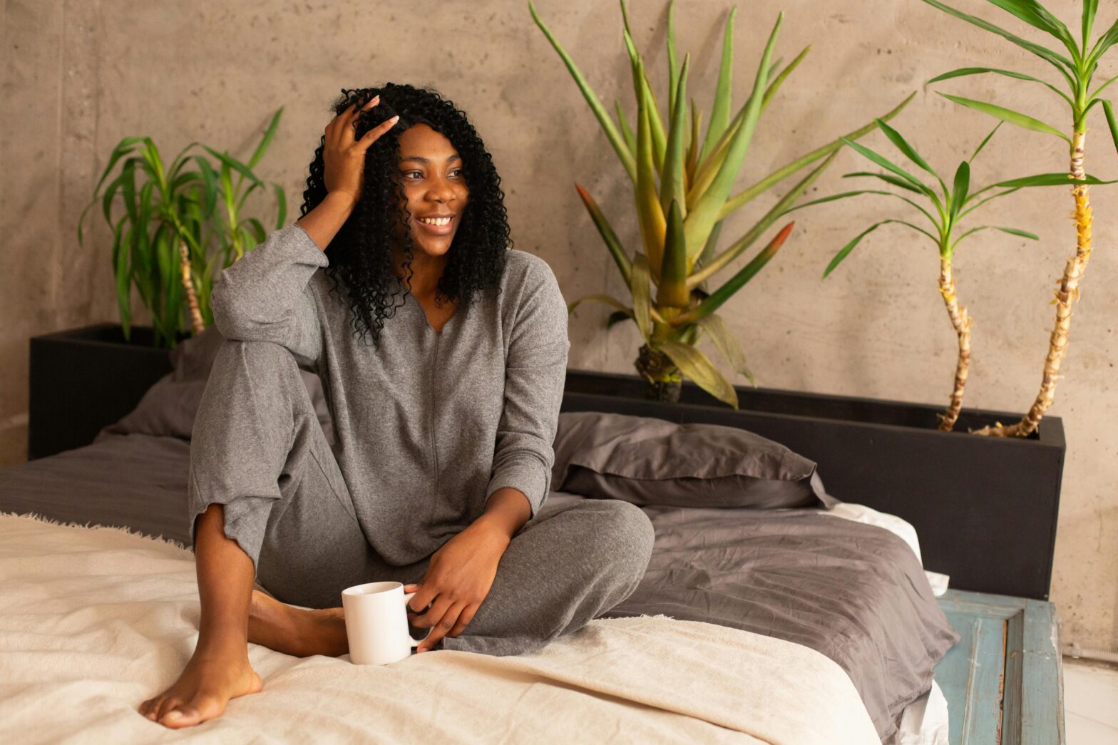 woman smiling sitting on bed