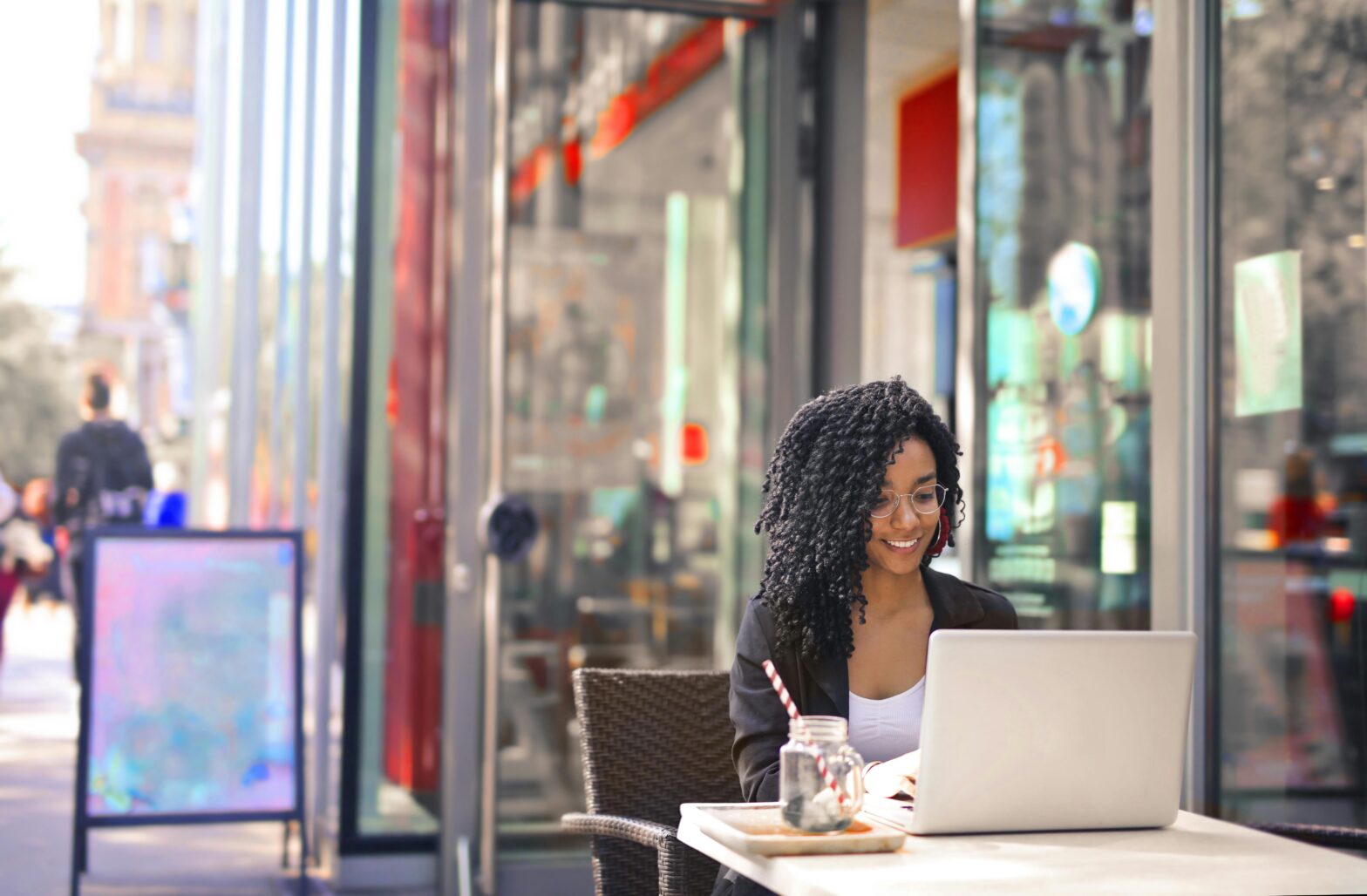 Learn more about the recent study on affordable cities in Europe for remote workers. pictured: a Black woman working remotely