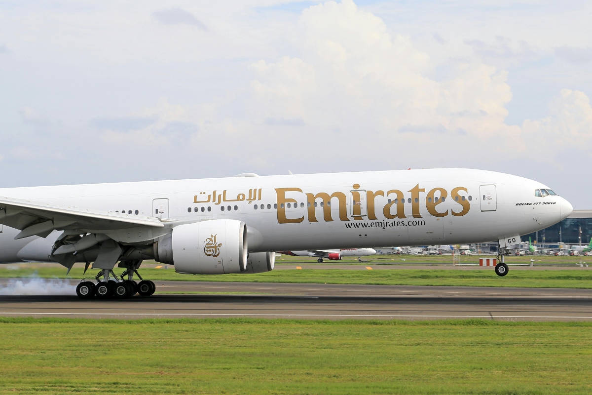 Emirates airplane departing from airport.