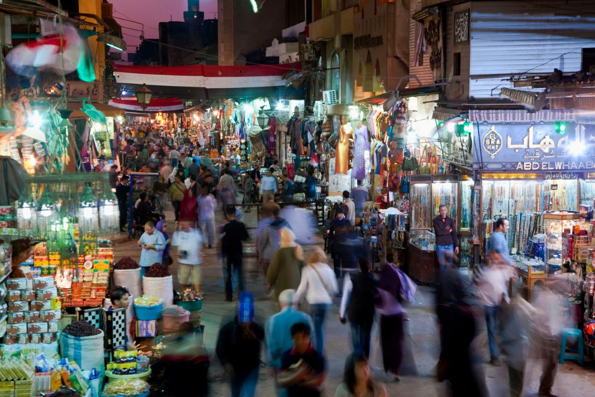 crowd of people walking through market in Cairo, Egypt at night