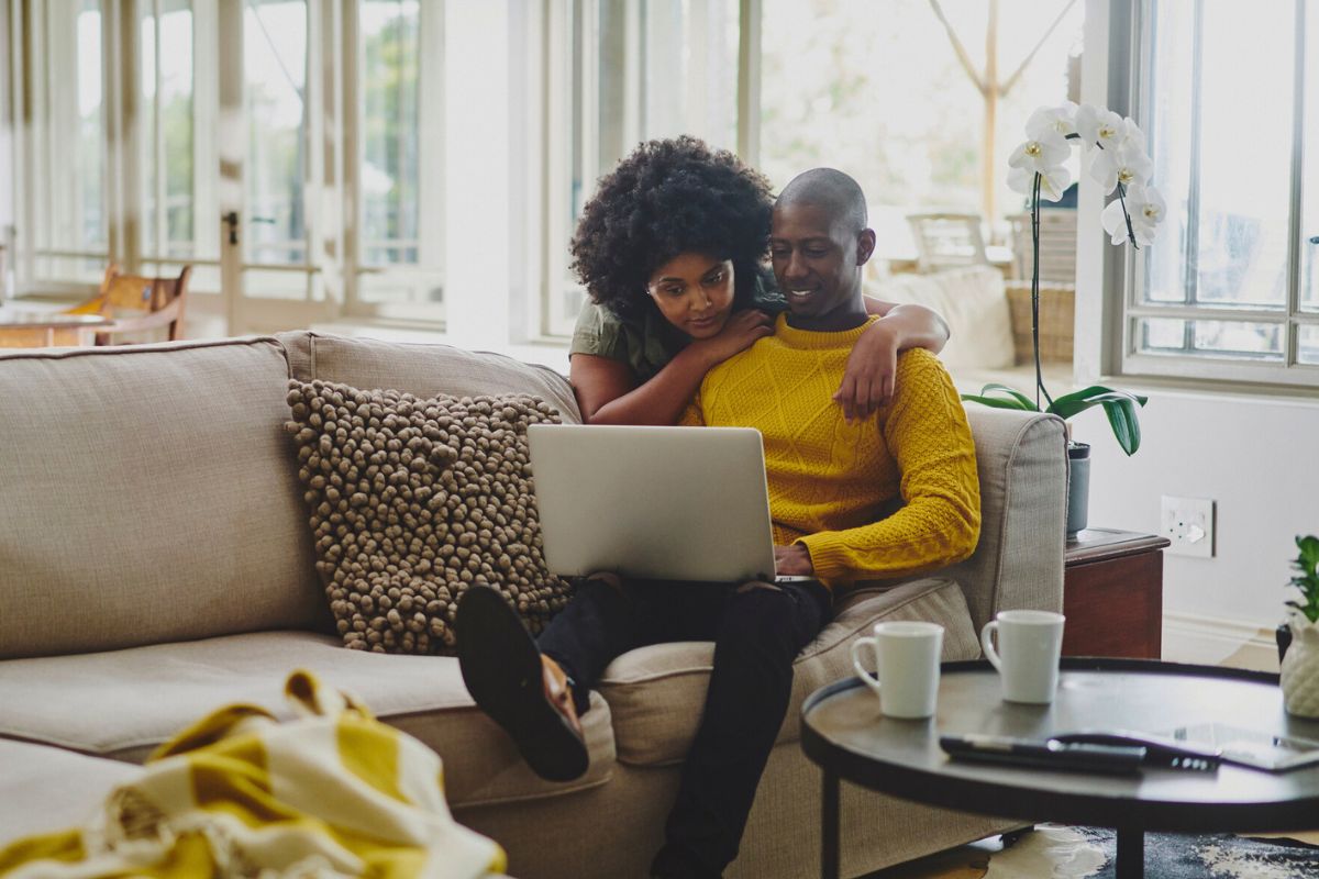 couple looking at laptop together in their living room