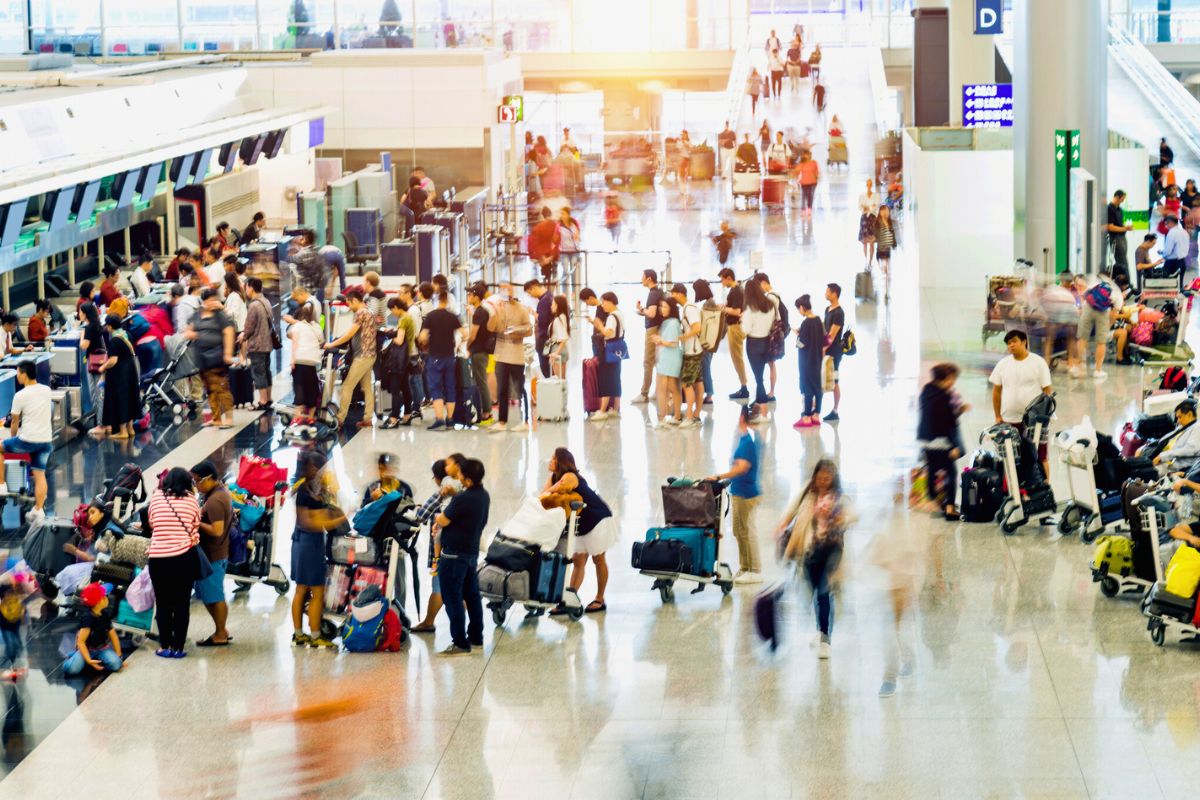 crowd of people in airport check-in lines