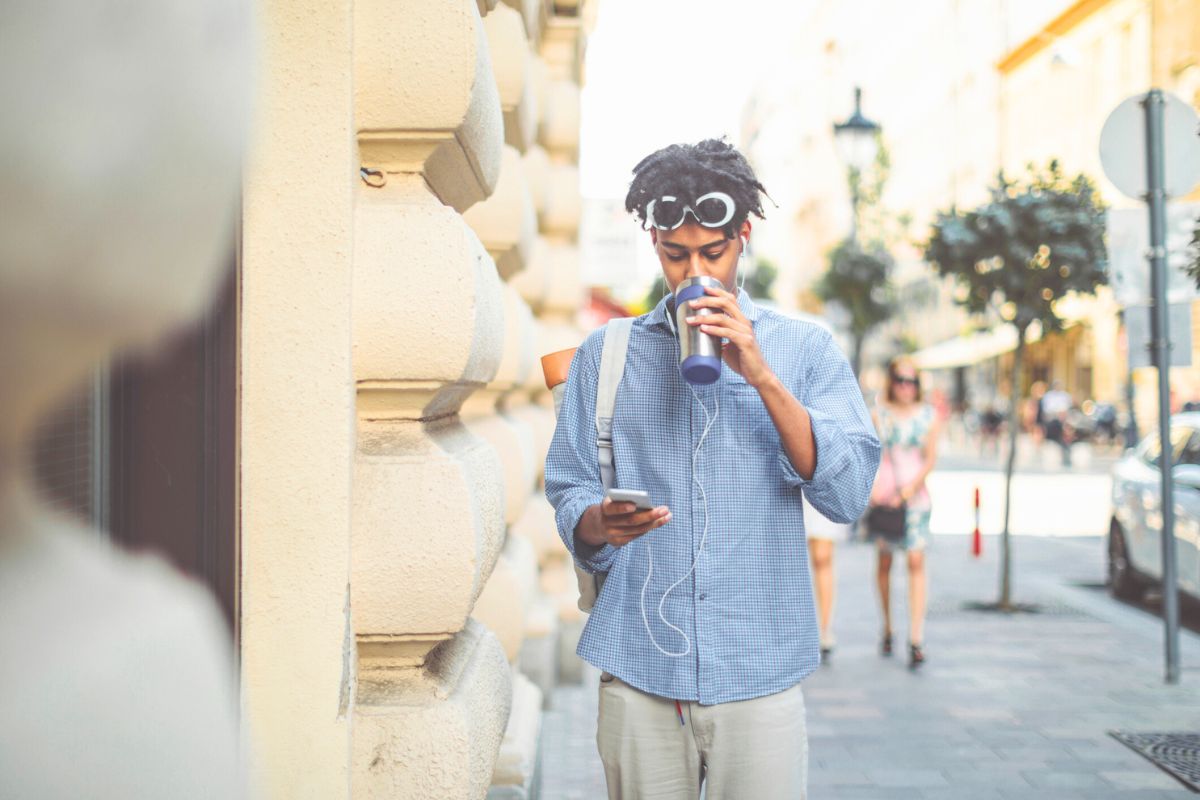 man walking on street in Hungary while listening to music