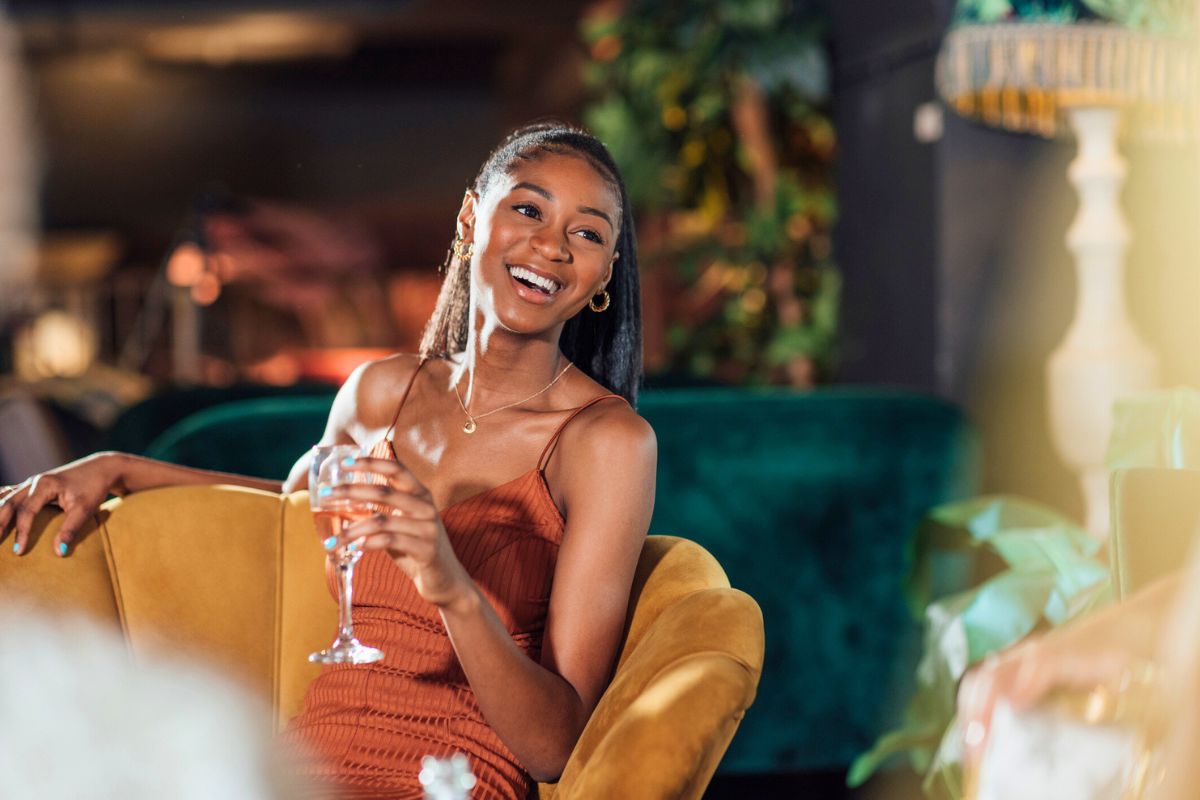 woman enjoying champagne in fine dining restaurant