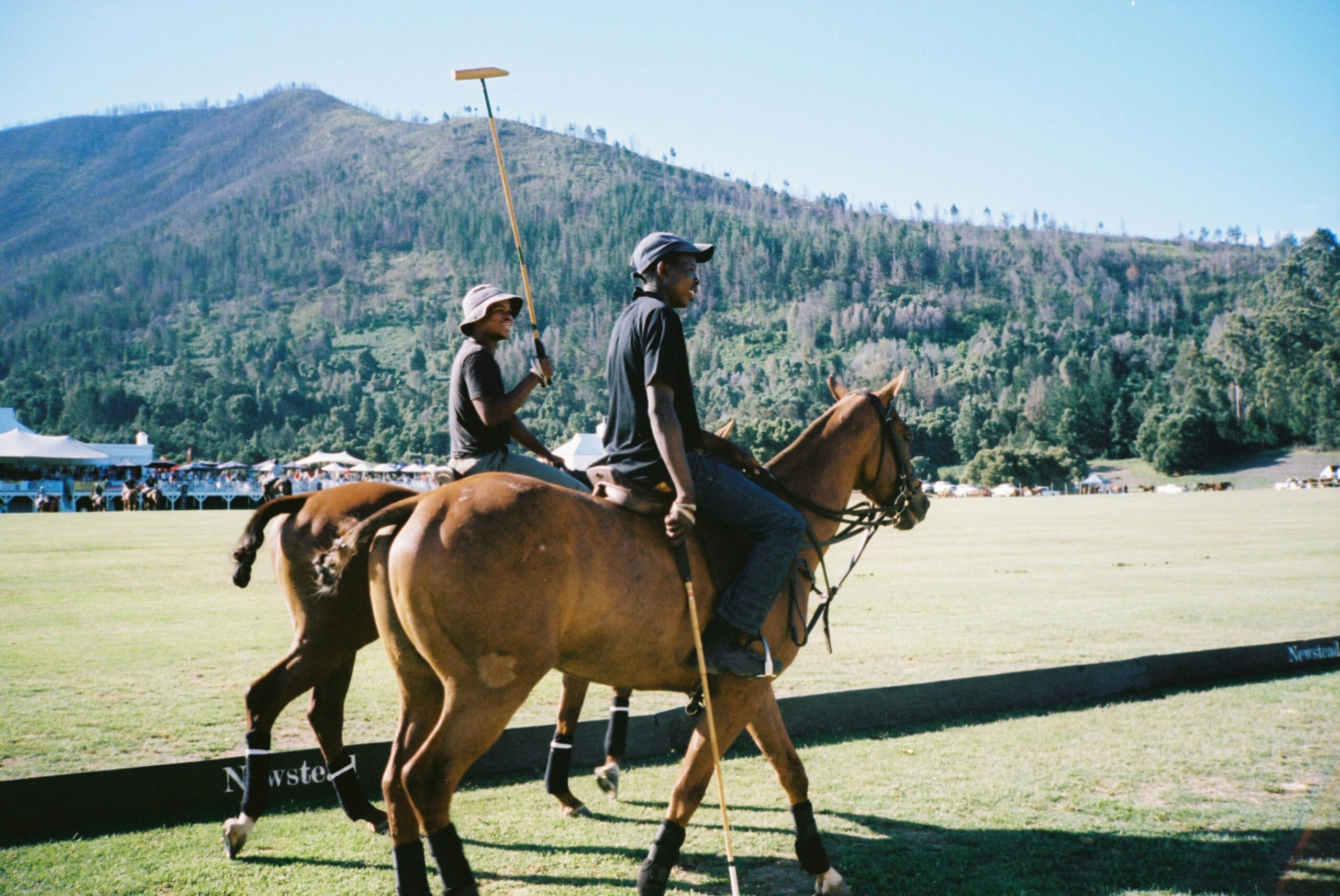 Polo is a unique sport that is played in Barbados. Travelers can try it out during their dry season visit. 
pictured: two Black men playing polo