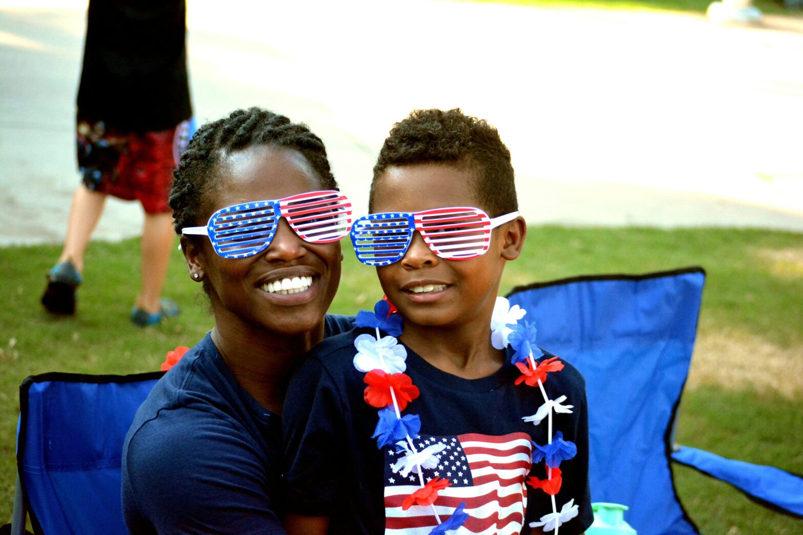 Traveling to celebrate Independence Day is an exciting adventure, these are the top destinations. pictured: a Black mom and son on the Fourth of July