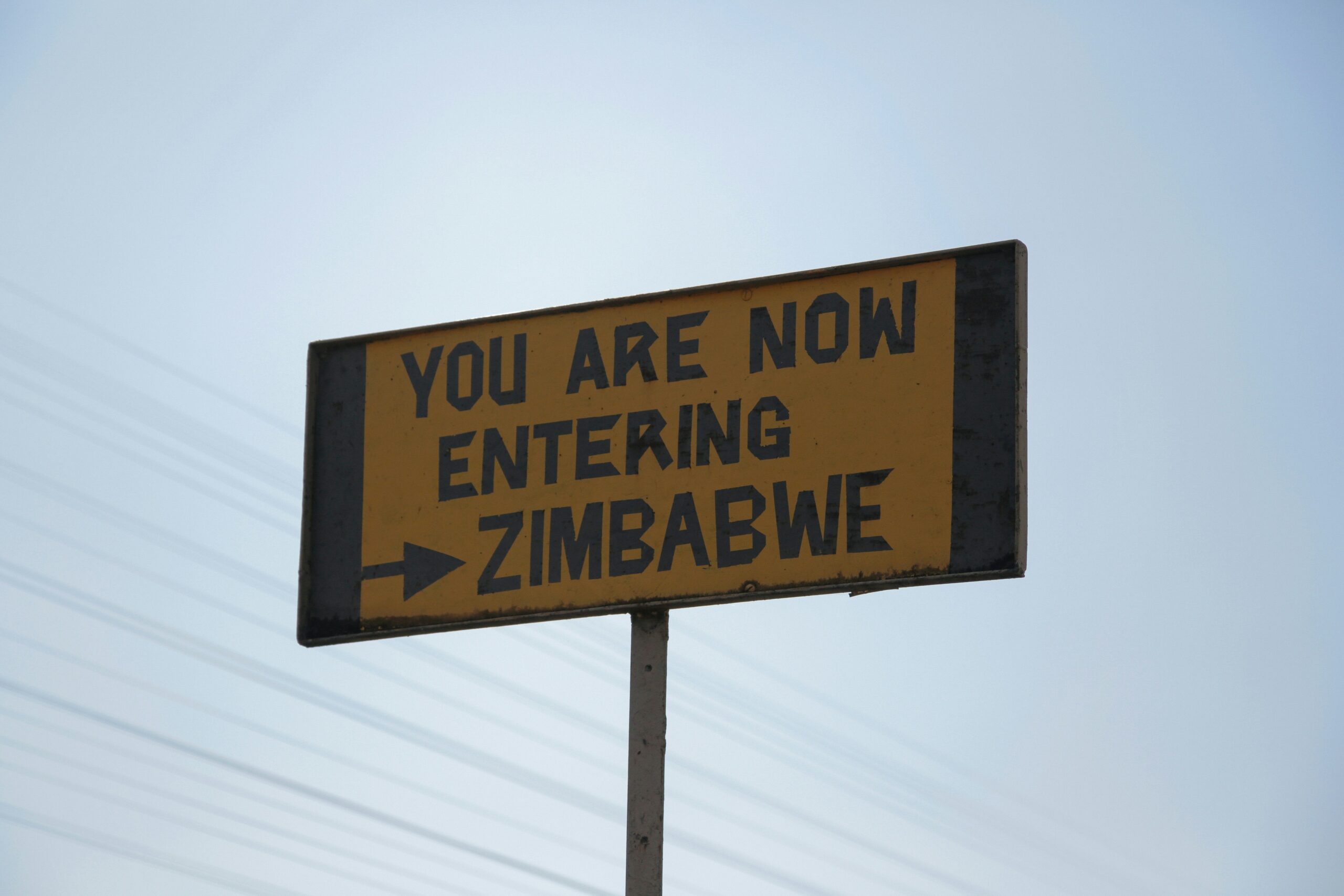 The unique ruins are a reason that travelers enjoy Zimbabwe. 
pictured: Zimbabwe entrance sign