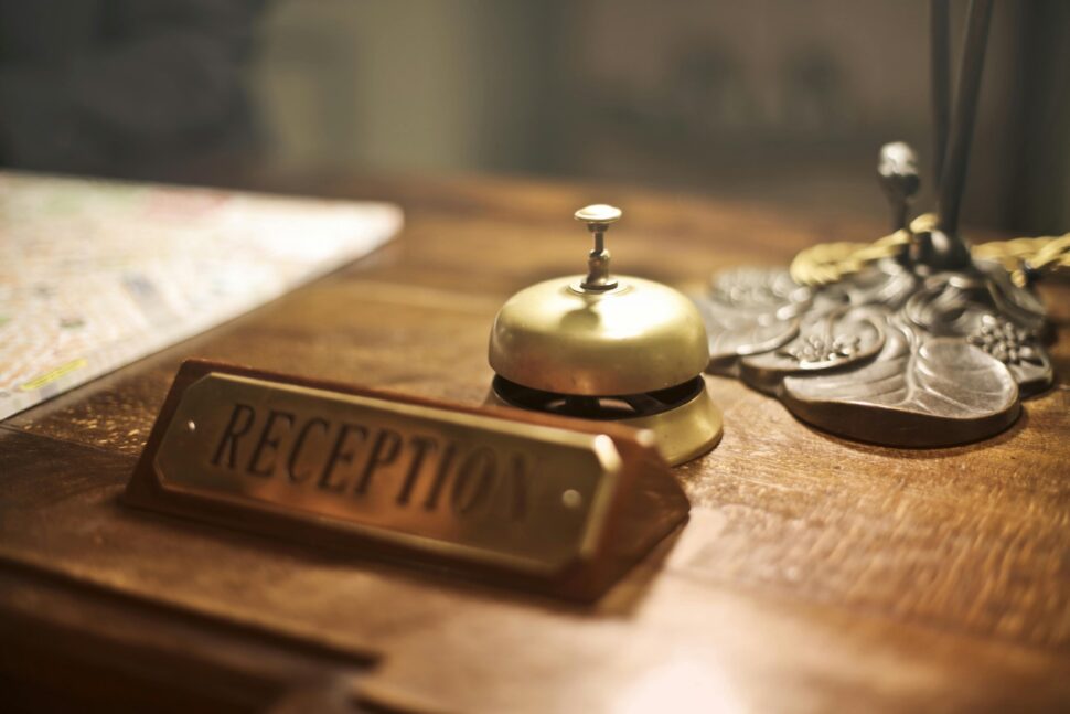 reception sign at a hotel front desk