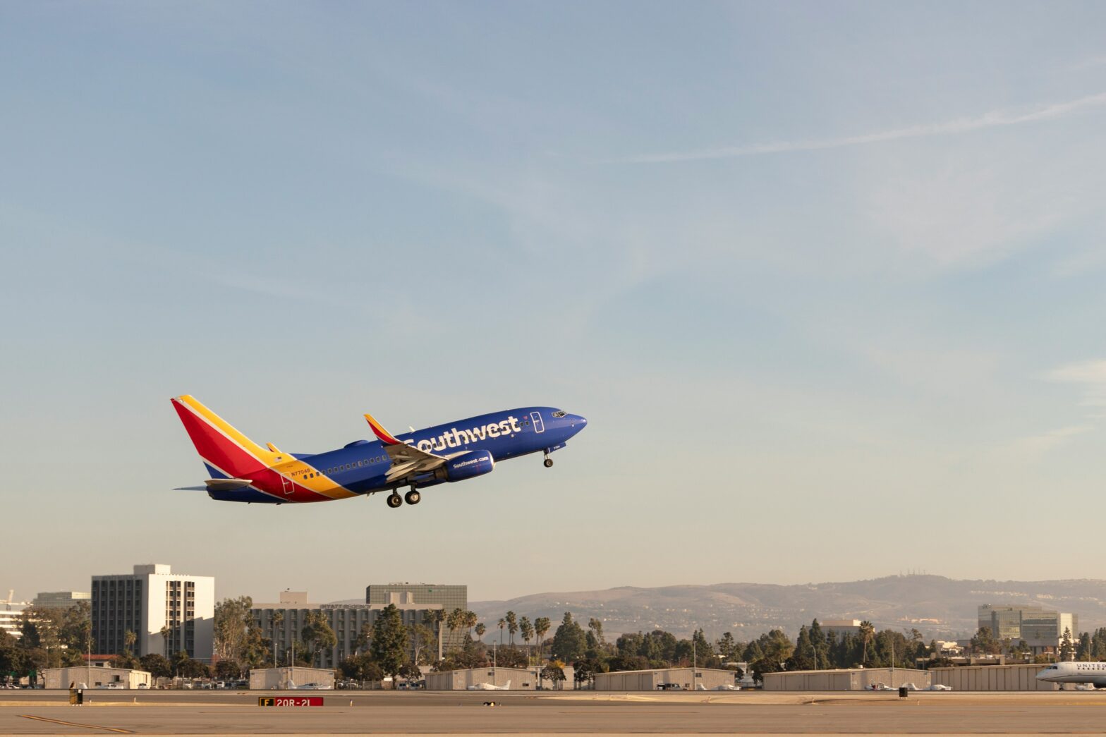 Southwest airplane taking off on runway during the day