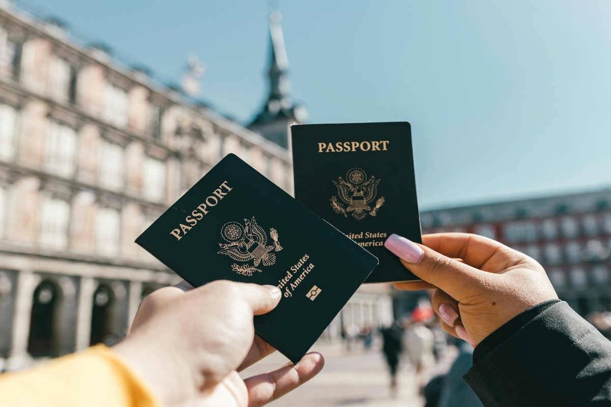 Tourists showing U.S. passports on street.