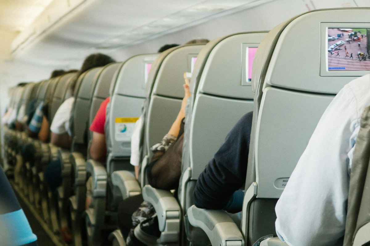 People sitting in airplane seats.