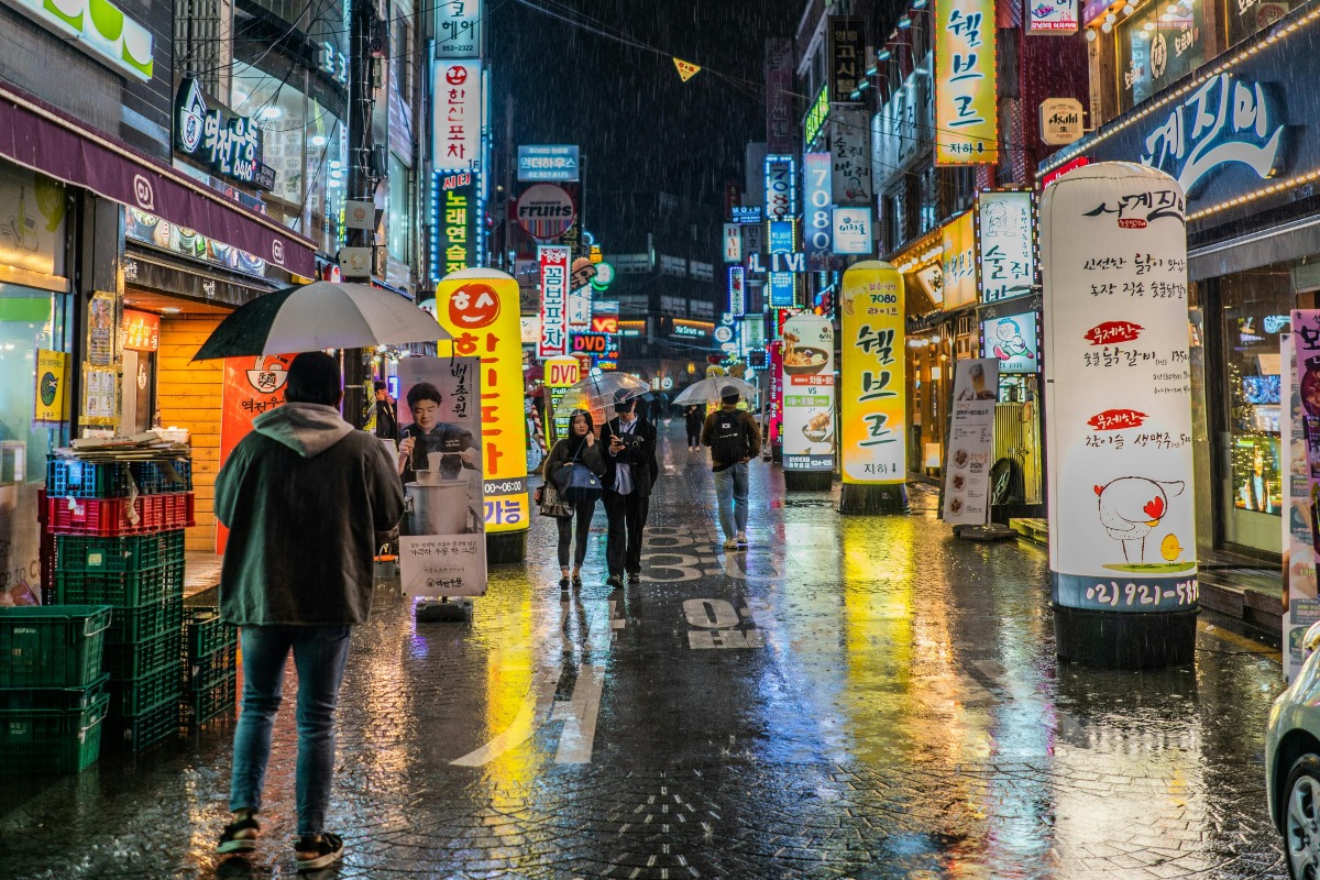 Person Wearing Black Jacket Holding Black Umbrella Walking on Street