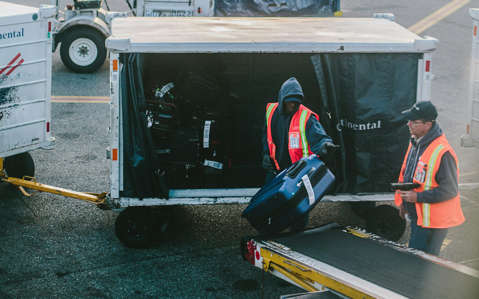 Men moving luggage onto a plane.