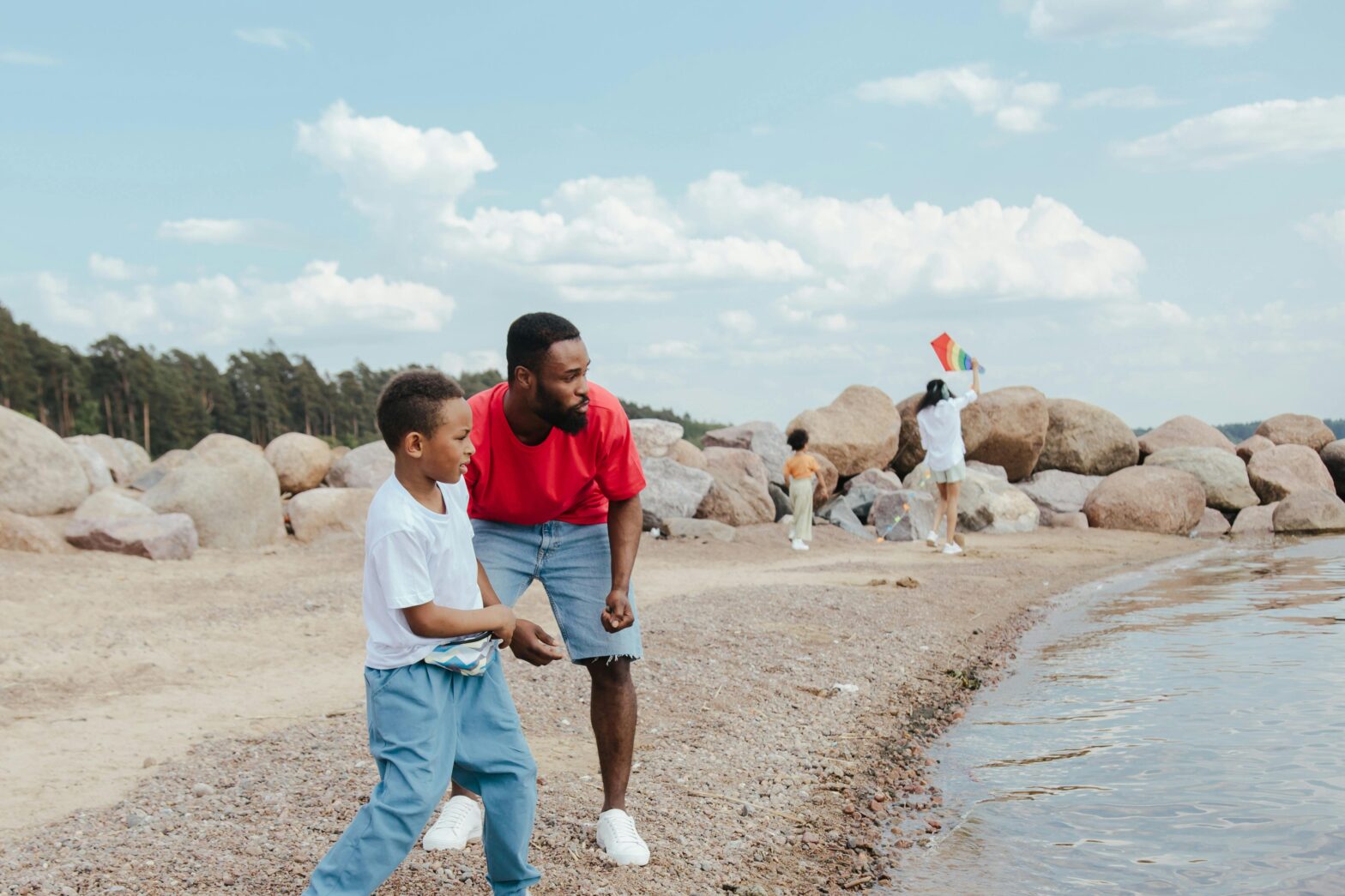 There are many underrated places that travelers can visit with their families. Pictured: a Black family on the beach