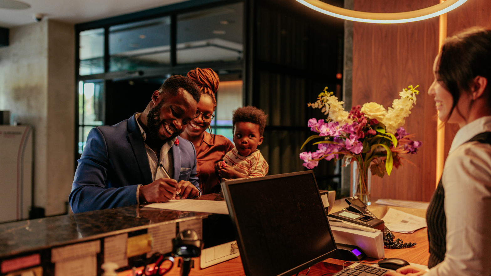 Family checking in putting babies to bed in hotel closets