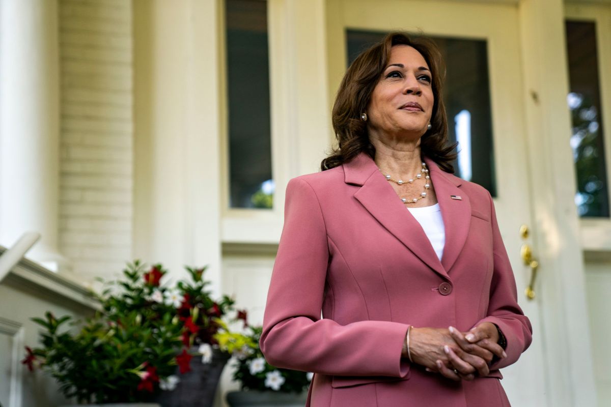 Vice President Kamala Harris standing in front of a home