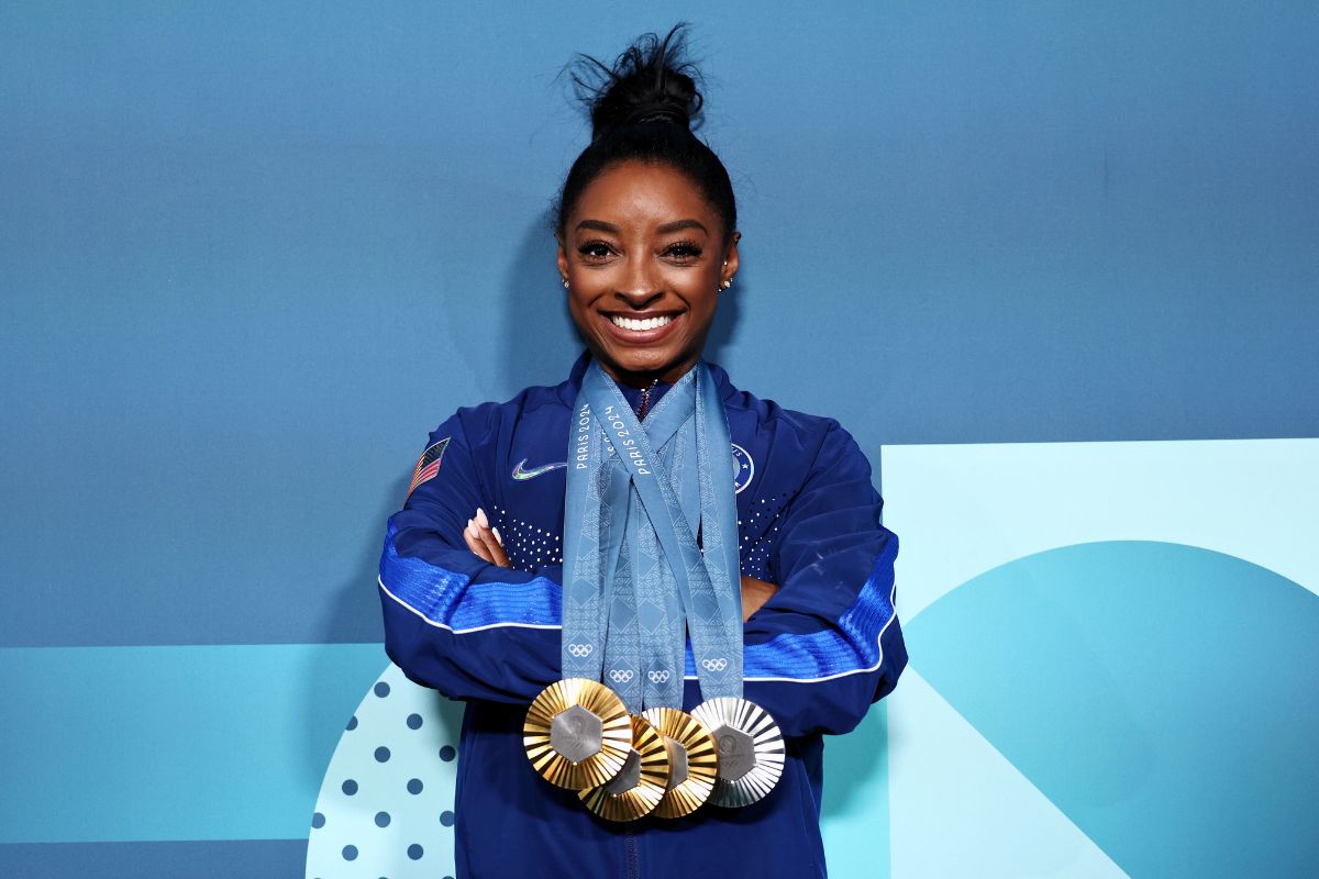 Simone Biles of Team United States poses with her Paris 2024 Olympic medals following the Artistic Gymnastics Women's Floor Exercise Final at the Olympic Games Paris 2024