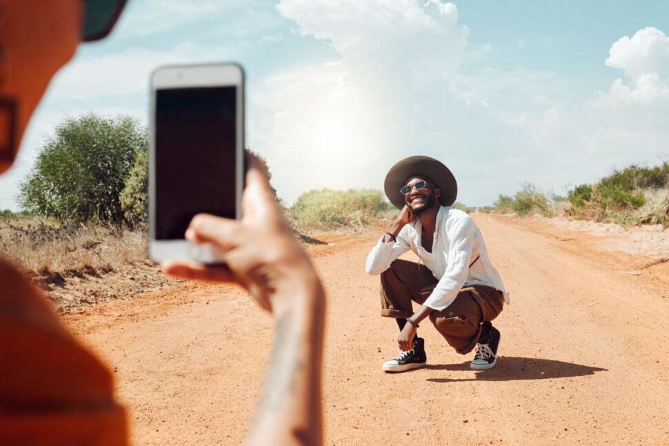 travel influencer posing for a photo on a dirt road