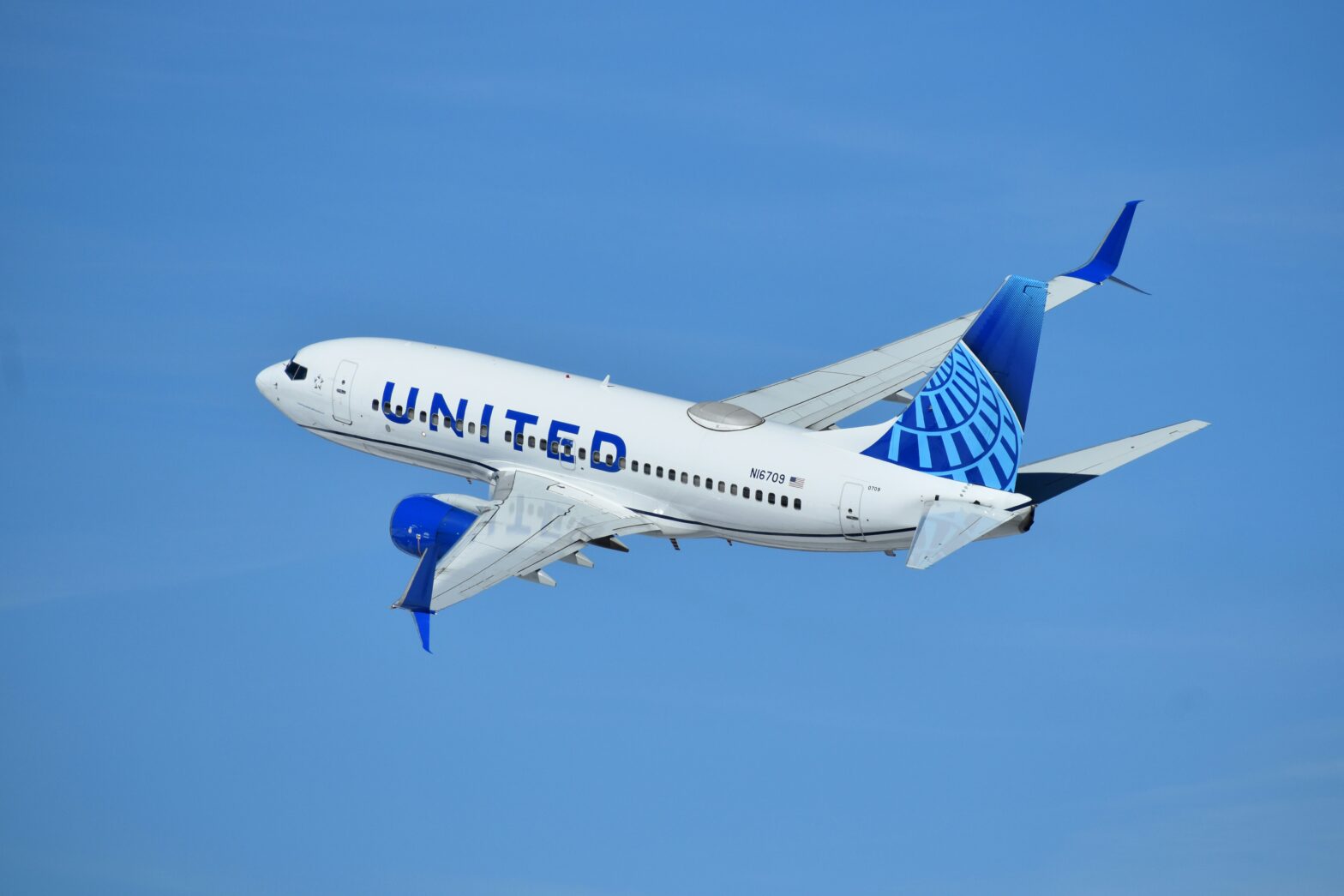 A daughter surprises dad on a plane in this adorable video. pictured: United aircraft