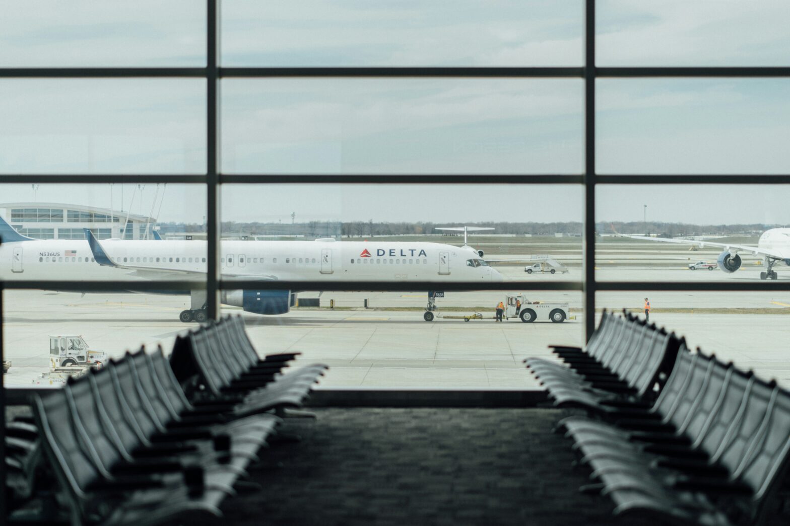 A gate agent has gone viral for his high energy and positivity. pictured: delta gate at airport looking out window