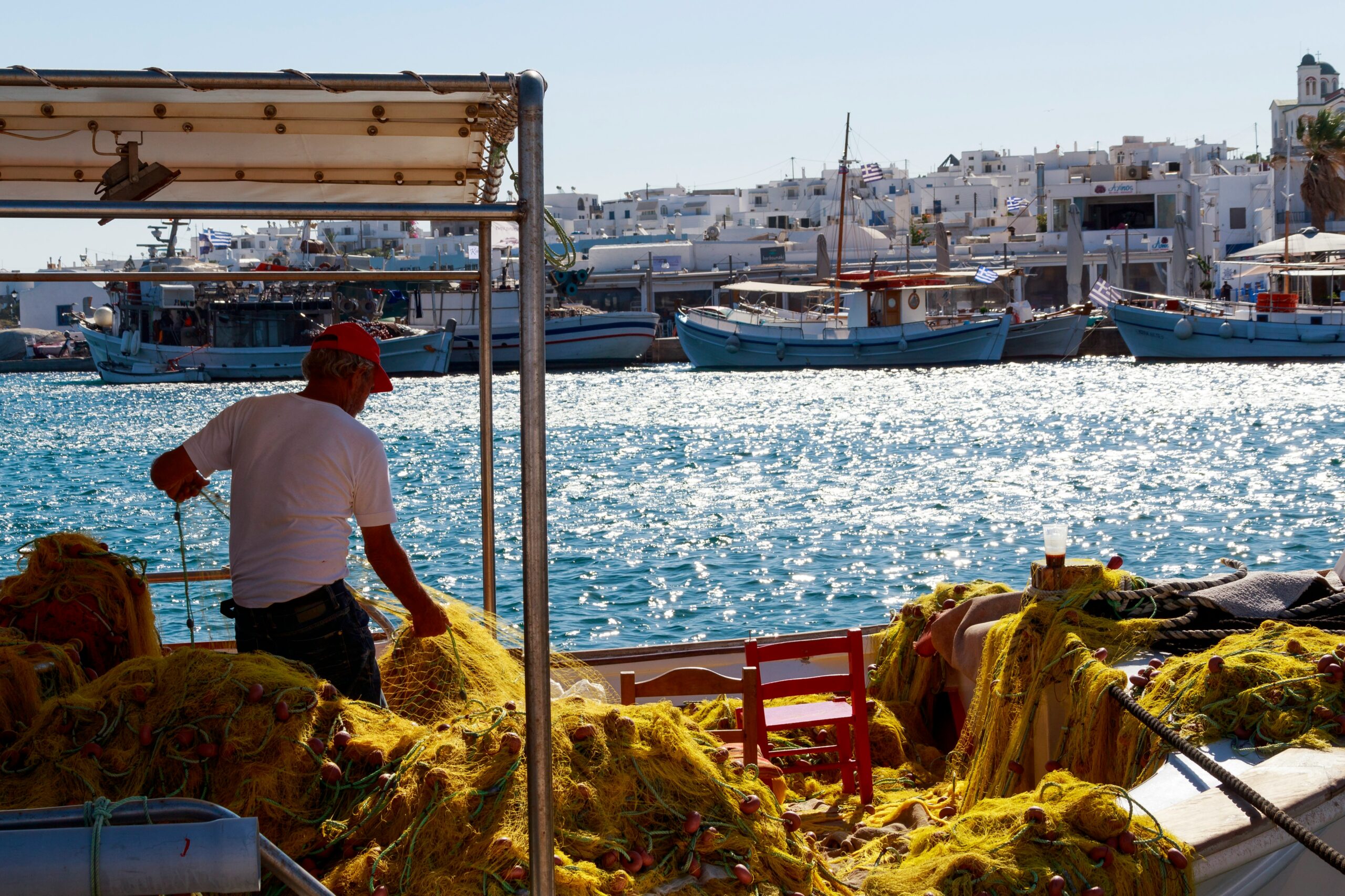 The food in Paros is a big appeal for travelers. 
pictured: man in Paros fishing