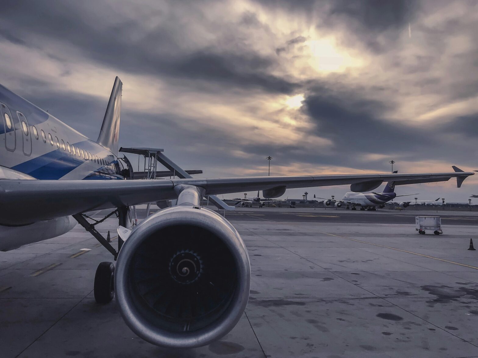 close shot of aircraft wing and engine on a cloudy day