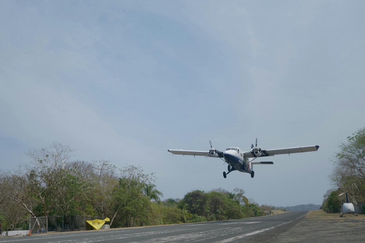 A small plane landing on a runway.