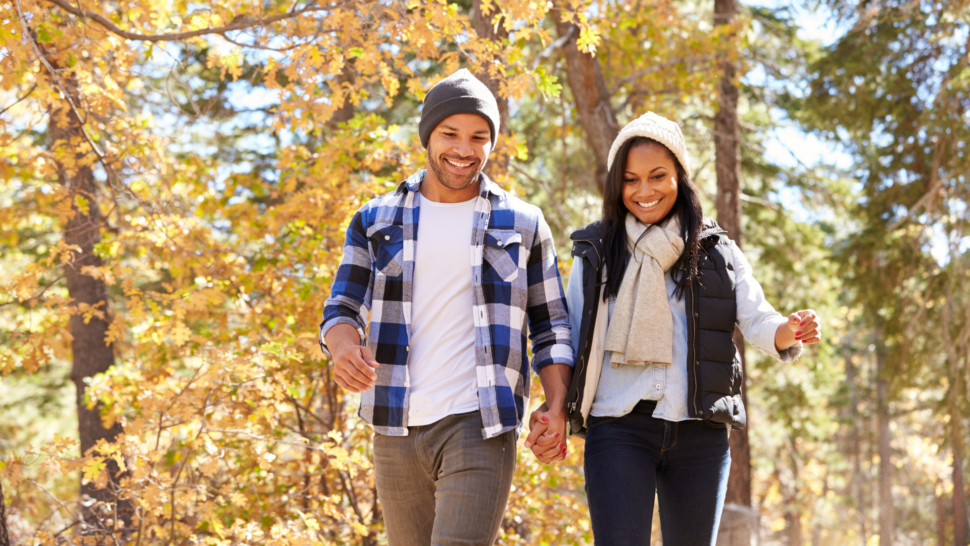 African American couple hiking in autumn