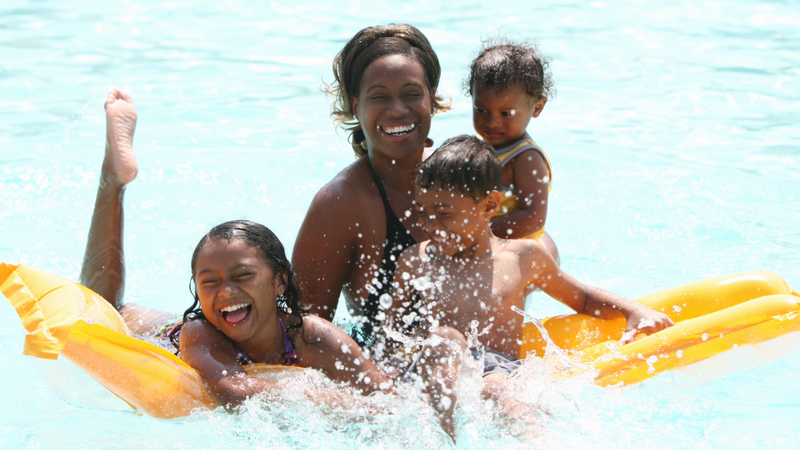 African american family playing in the pool