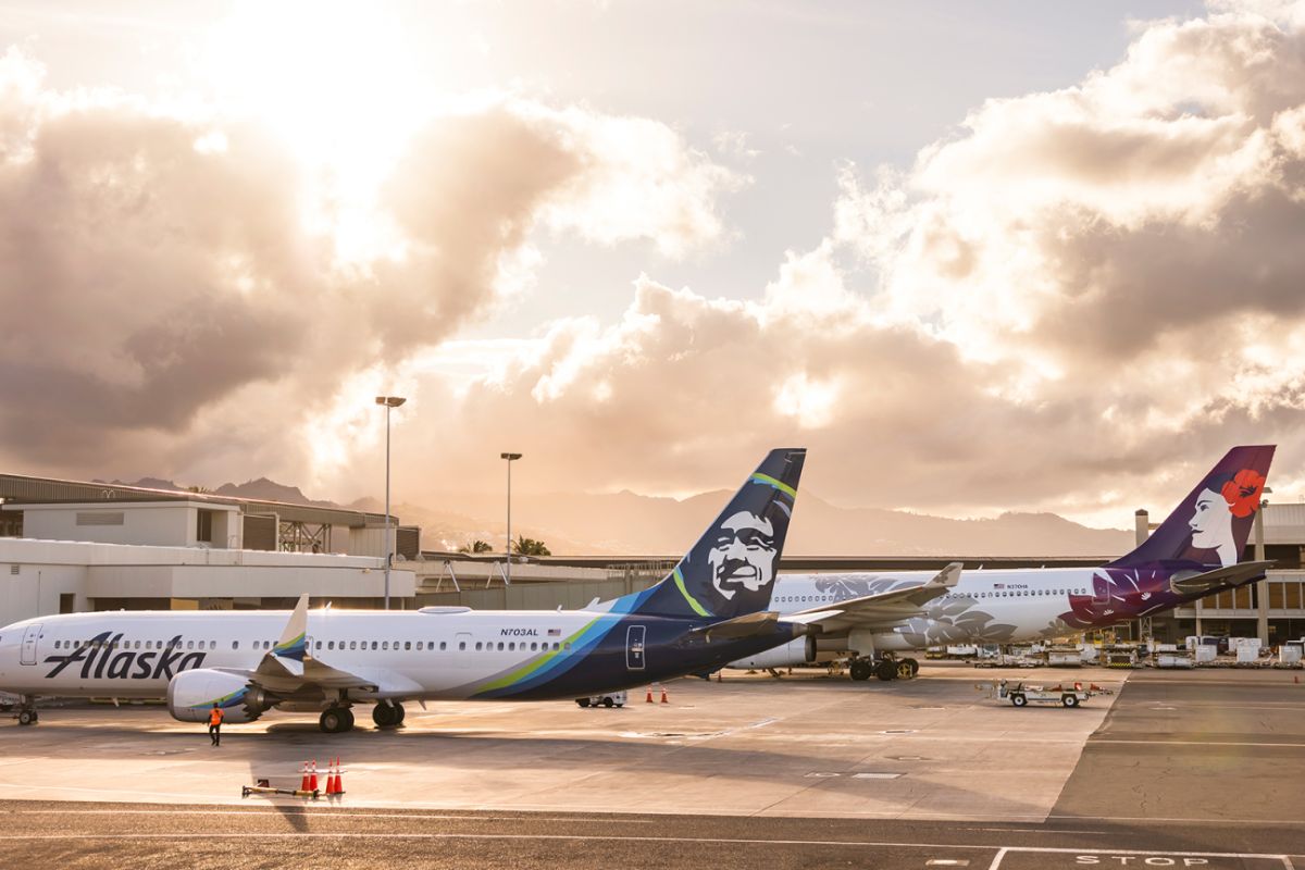 Alaska and Hawaiian Airlines planes sitting side-by-side at gate