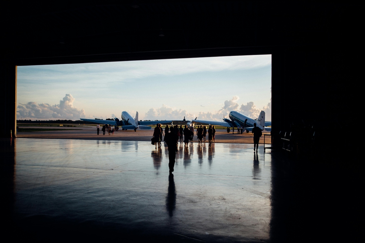 Crowd of people walking towards airplane