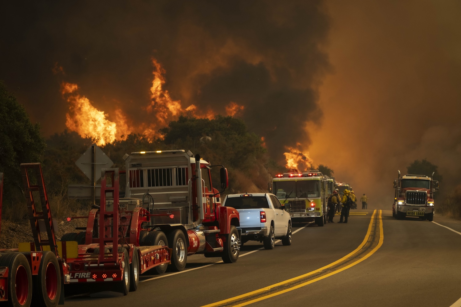 Costa Mesa Firefighters along with Cal Fire work to navigate the Airport Fire as it overtakes Ortega highway.