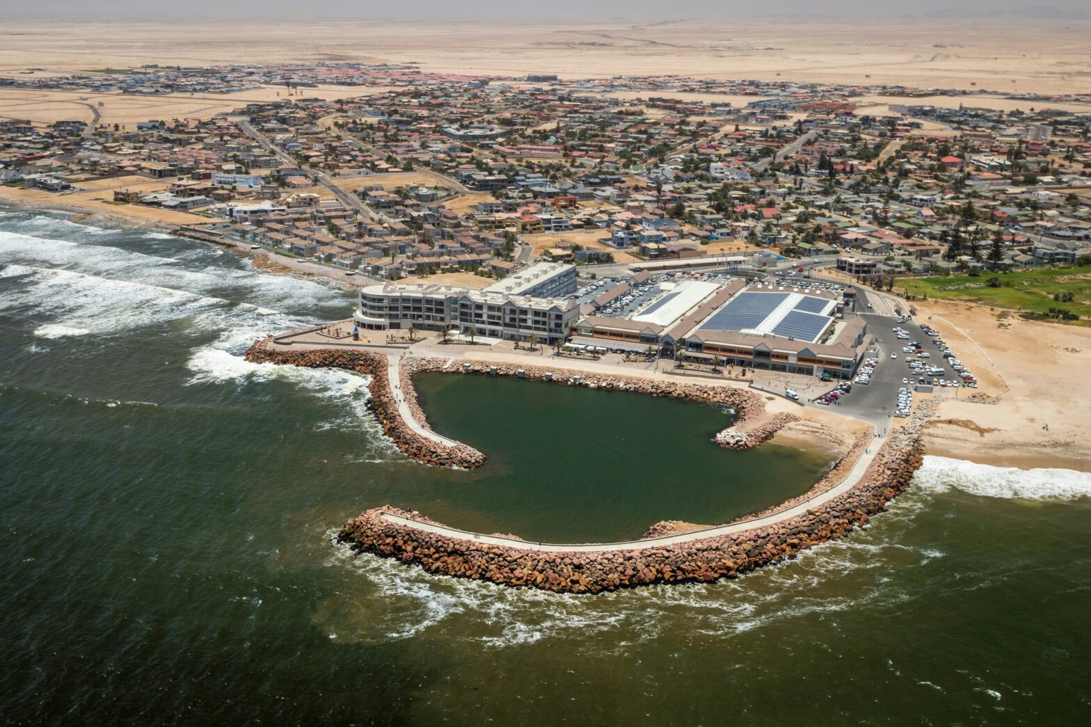 coastline of Namibia, Africa with red sand dunes in the distance