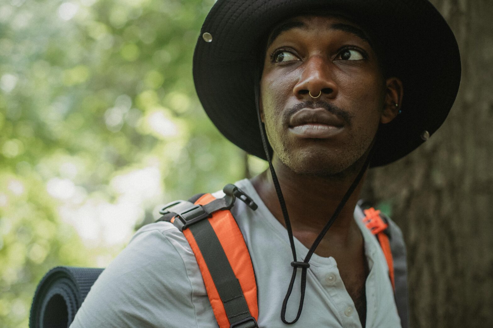 Black male hiker looking worried.