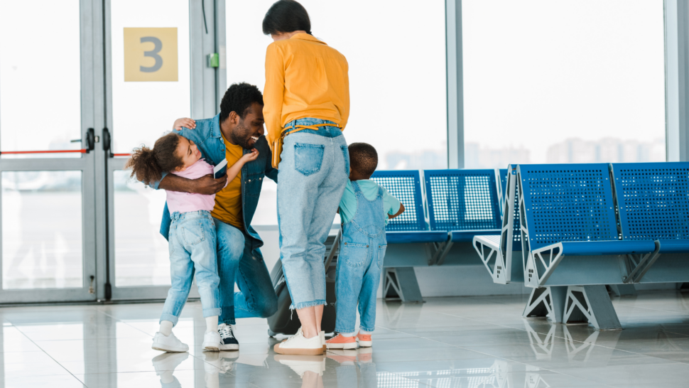 Family hugs in an airport