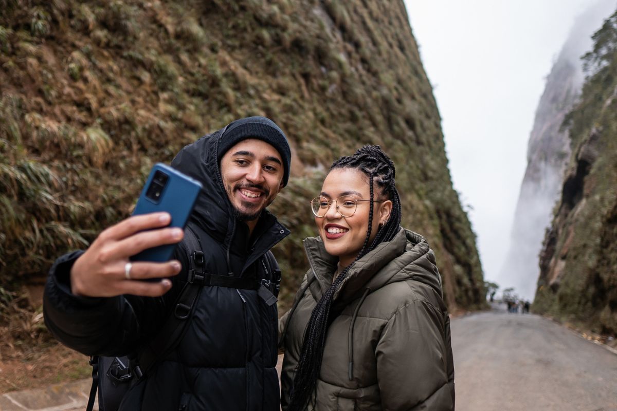 tourist couple taking selfie during winter