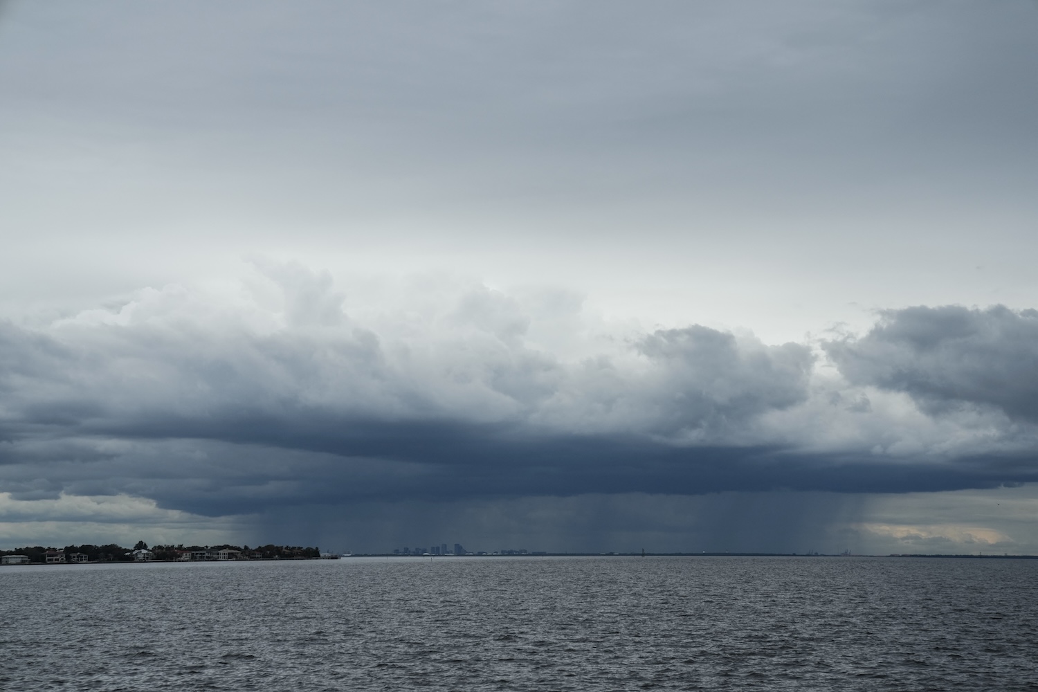 A thunderstorm can be seen moving over Tampa in the distance from St. Petersburg, Florida ahead of Hurricane Milton's expected landfall.