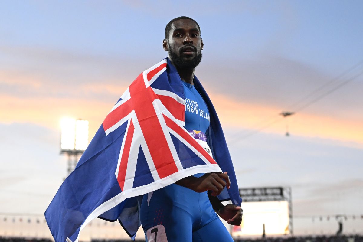 Kyron McMaster holding British Virgin Islands national flag