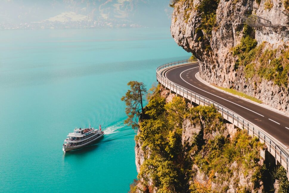 A cruise ship sailing through beautiful blue water in Lake Thun, Switzerland.