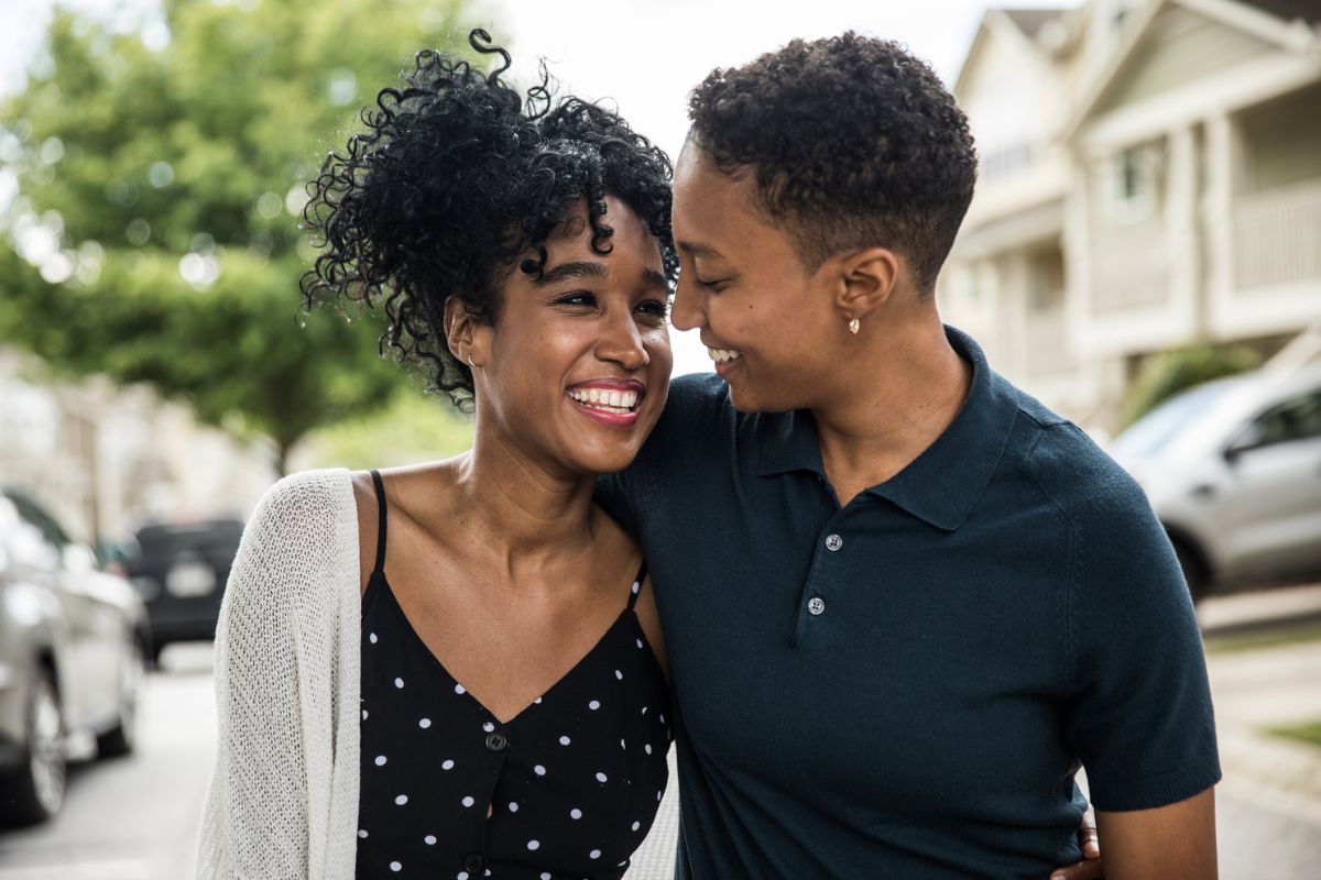 lesbian couple walking in a neighborhood