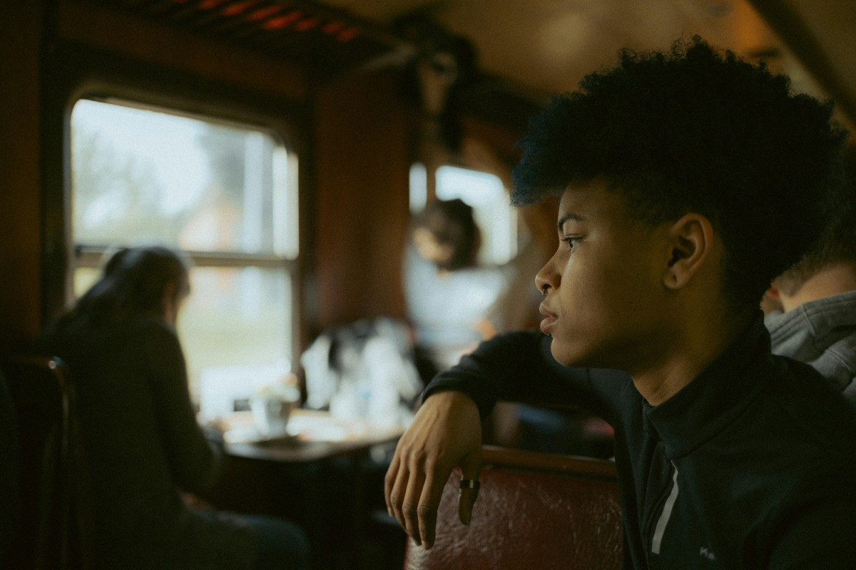 Side View of a Young Person Sitting in a Train