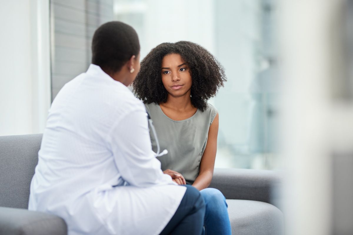 young woman talking to a female doctor