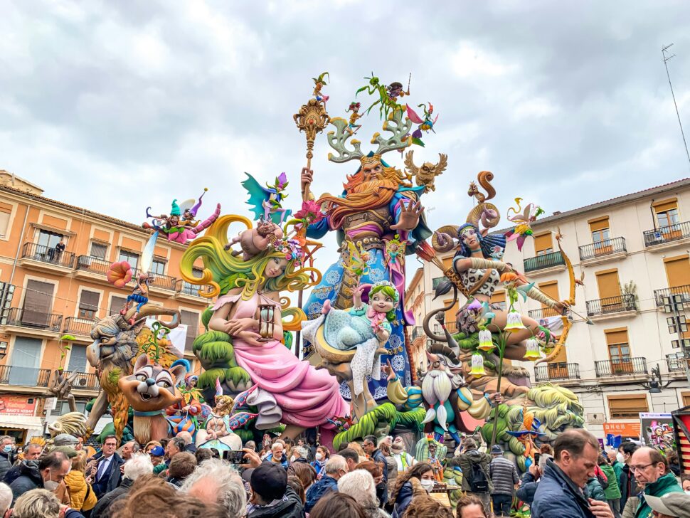 A large, complex colorful statue surrounded by a crowd for the Las Fallas Festival in Valencia, Spain. 